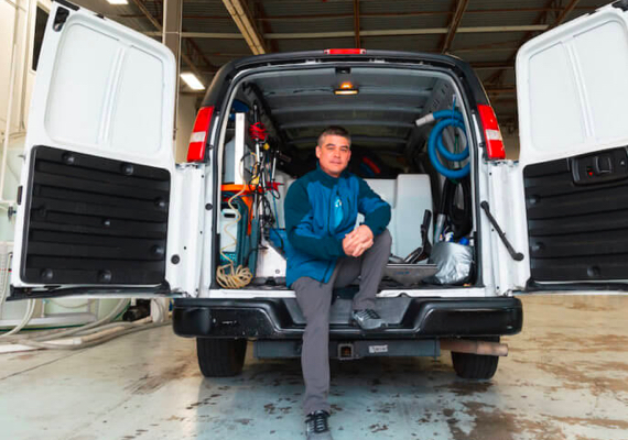 Man sitting in the back of a work van