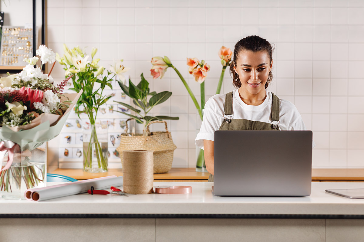 woman working on laptop in kitchen.