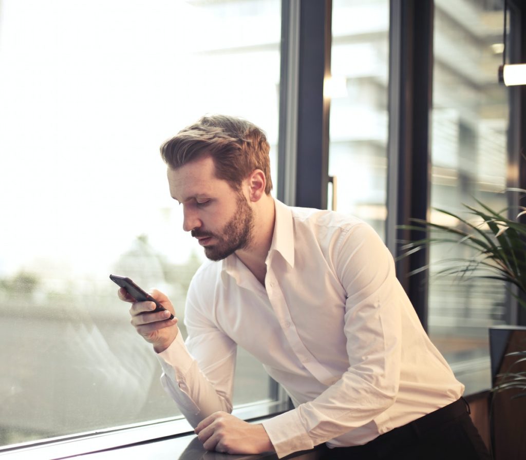 man looking at text on mobile phone
